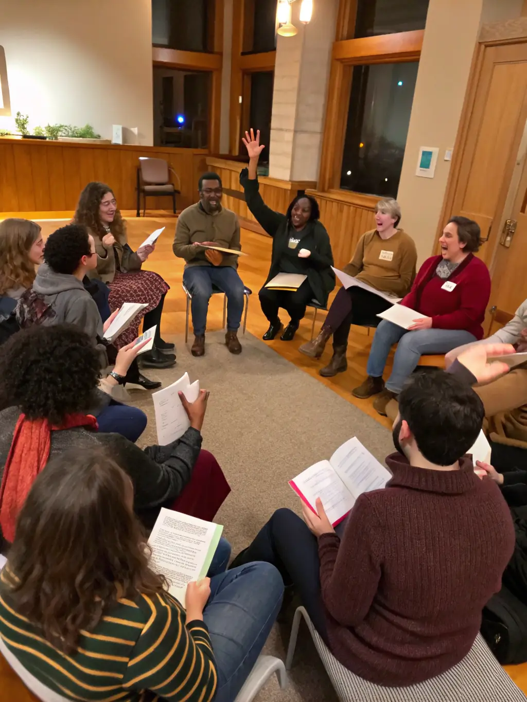 A diverse group of people sitting around a table in a brightly lit room, engaged in a mediation session, with a mediator facilitating the discussion, showcasing interpersonal dispute resolution.